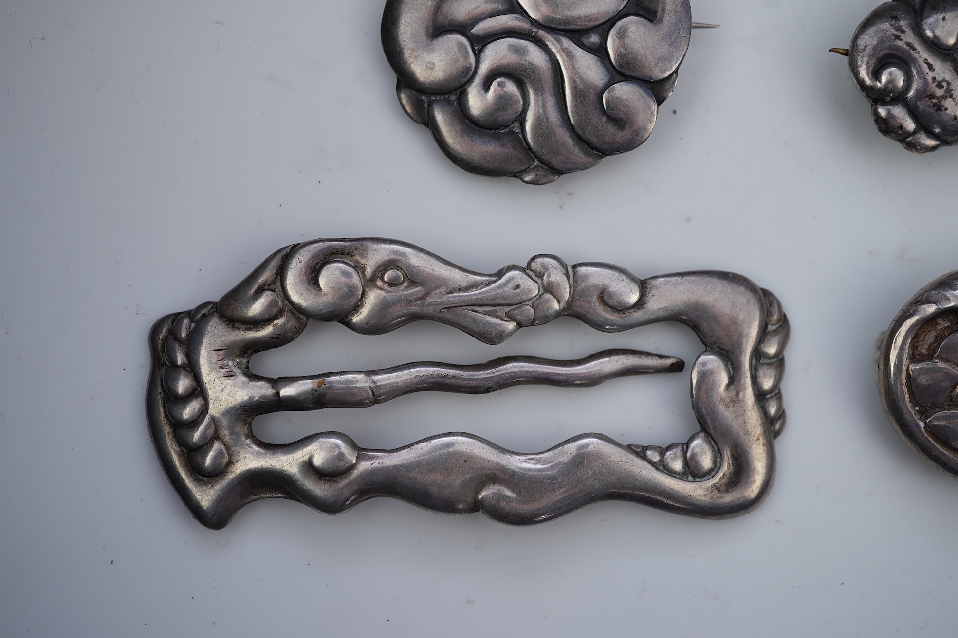An Arts & Crafts silver slide and three silver brooches, probably Denmark, first half 20th century